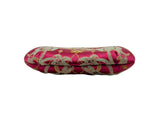 A small, rounded coin purse made of pink brocade fabric with gold and silver floral patterns, featuring a gold-tone metal clasp frame, 