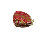 A small fabric coin purse with a red and gold floral pattern, featuring a gold metal frame and clasp closure, 