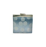 A small structured coin purse shown from the side. The purse has a glossy light blue background with silver circles - prominent silver-toned metal trim and frame details.