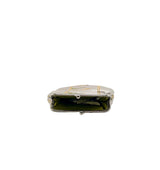 A vintage silver-toned clutch purse with gold trim and a green satin lining, shown from the front on a light gray background.