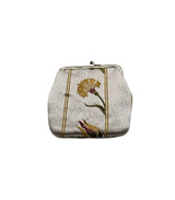 A small vintage-style coin purse with a silver metal kiss-lock clasp. The fabric body is a light cream/off-white color with vertical gold stripes and an embroidered yellow and green flower motif on the front.